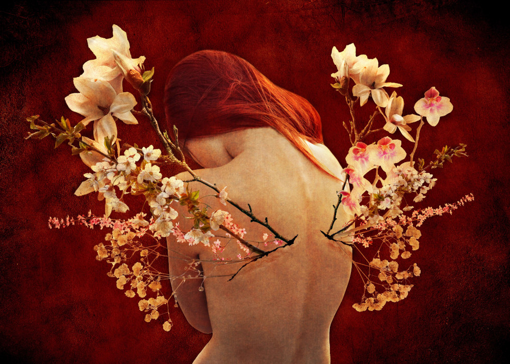 A woman showcases a beautiful arrangement of flowers, blossoming out of her back, blending nature with her graceful presence.